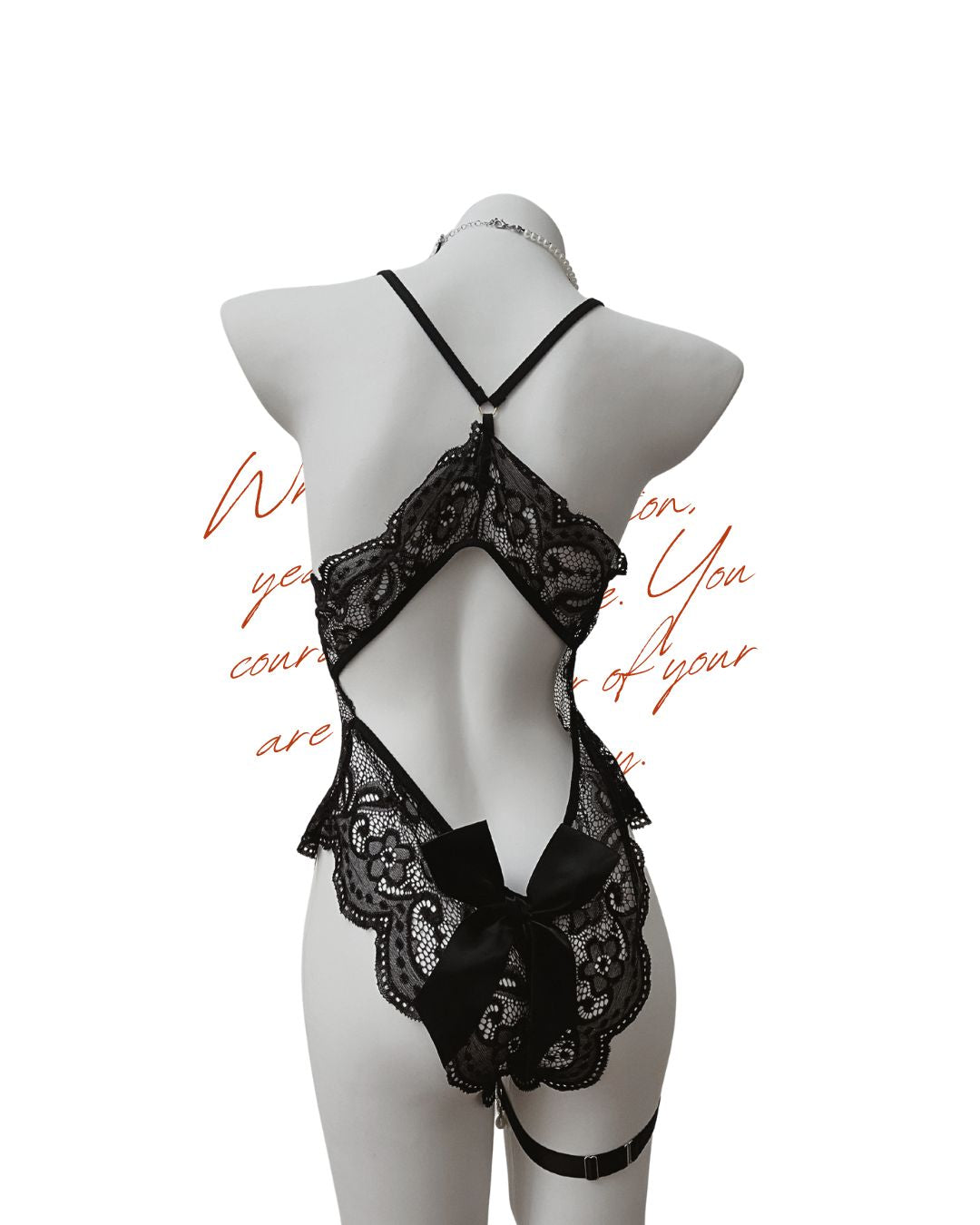 Black lace lingerie set on a mannequin against a white background