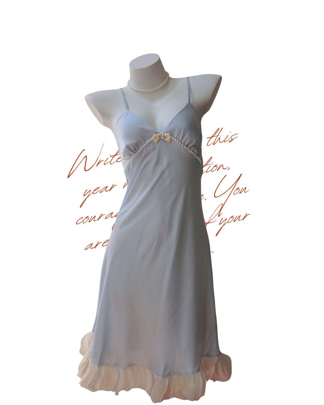 White blue nightgown on a mannequin with decorative elements against a white background