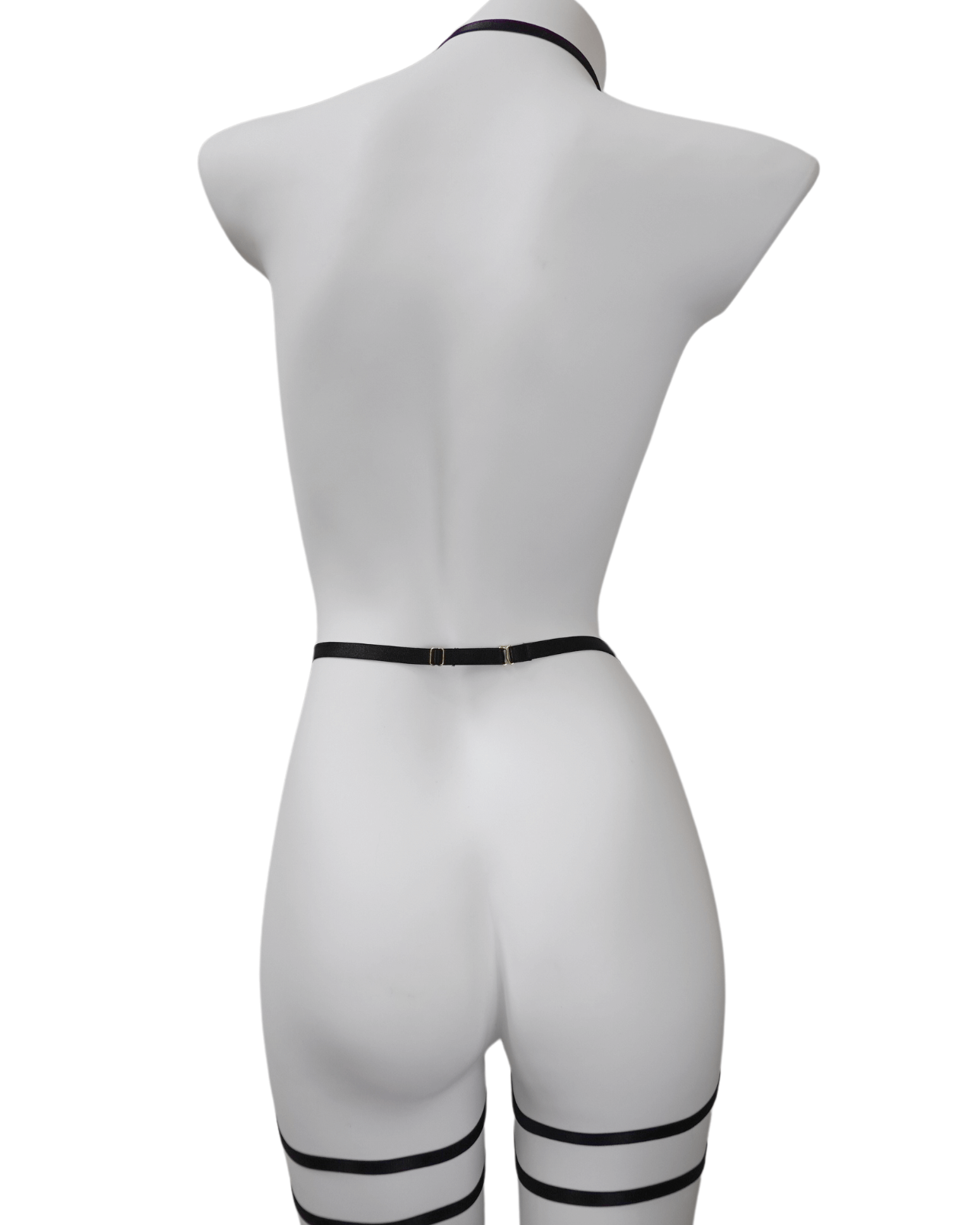 Back view of black strappy lingerie harness showing adjustable elastic fit and clean lines – soft bondage look
