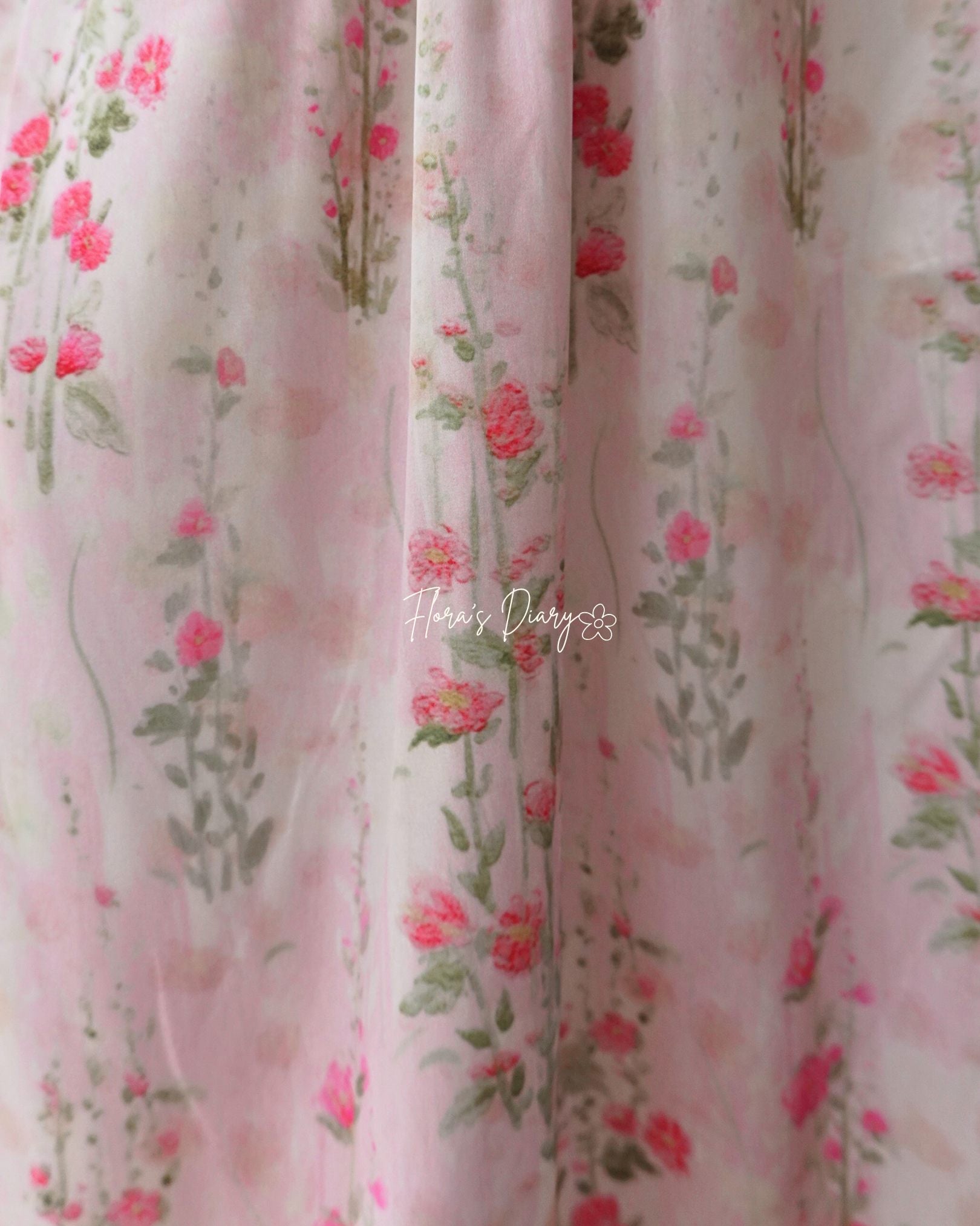 Floral patterned fabric with pink roses on a light background