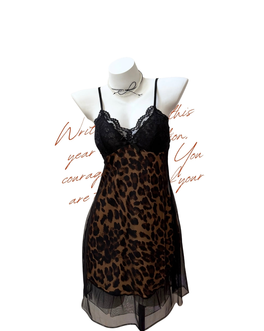 A black and brown leopard print babydoll chemise dress with a black lace bodice and thin spaghetti straps, displayed on a white mannequin torso against a white background with decorative red cursive text.