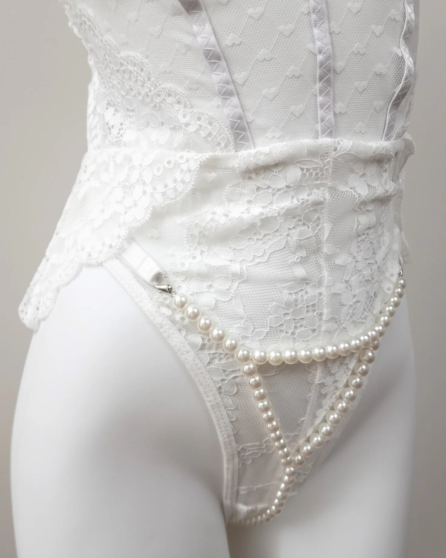 close-up view of Pearl Illusion Thong on white lace teddy lingerie