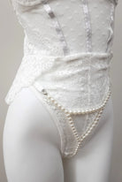 close-up view of Pearl Illusion Thong on white lace teddy lingerie