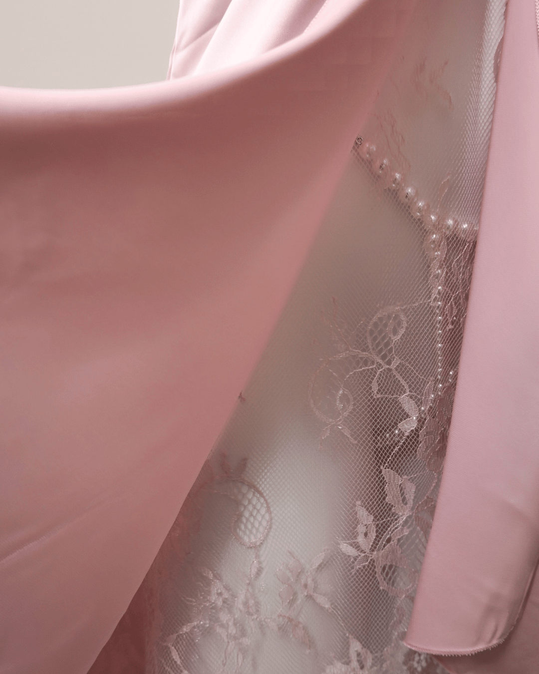 Close-up of Sweet Surrender nightdress showing sheer lace side panel and smooth satin fabric.