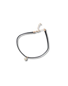 Black choker necklace with pearls on a white background