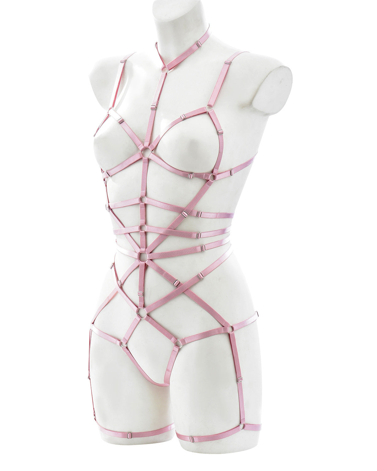 Back view of pink strappy lingerie harness showing elastic waist, thong cut, and adjustable shoulder and leg straps – soft bondage style