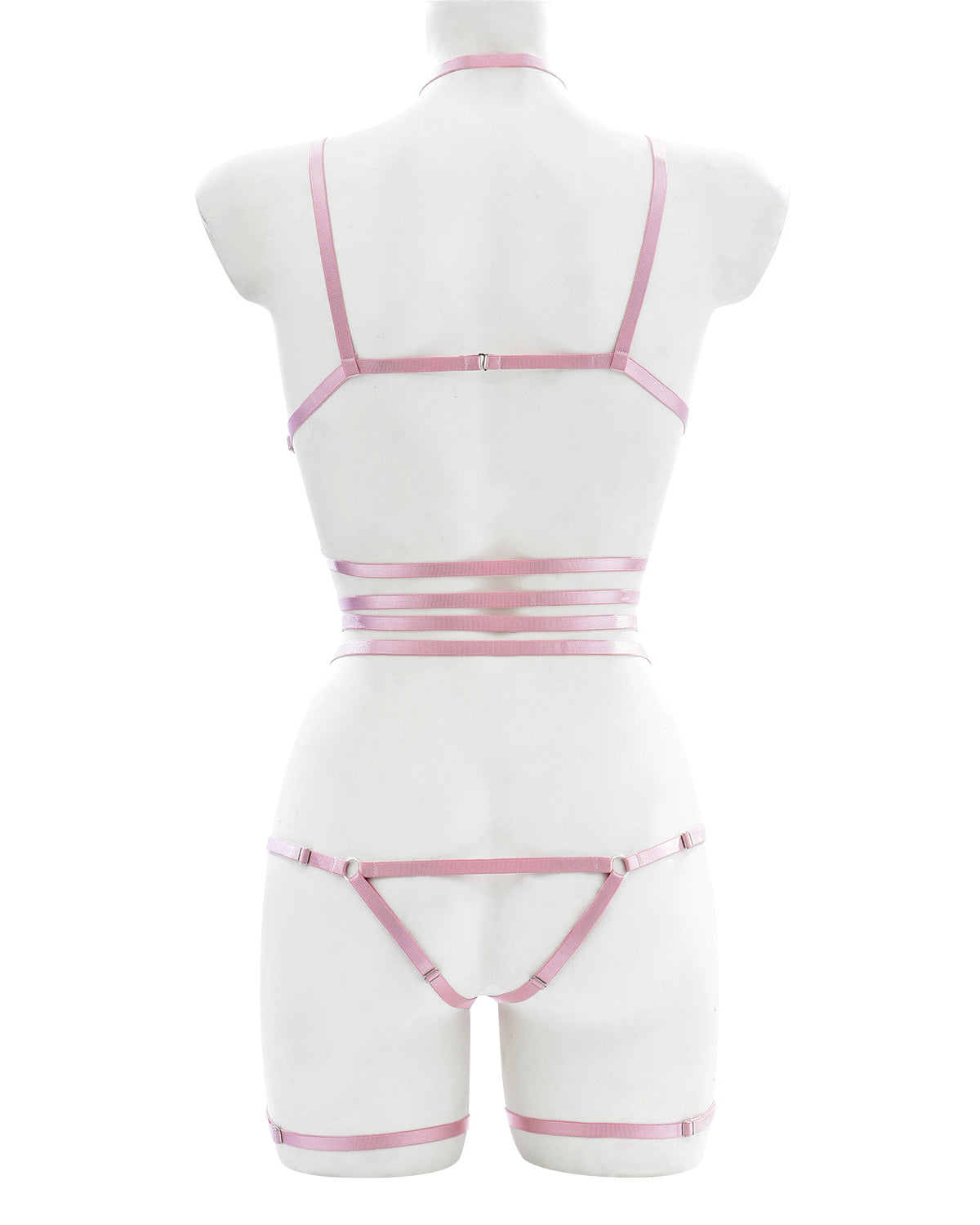 Back view of pink strappy lingerie harness showing elastic waist, thong cut, and adjustable shoulder and leg straps – soft bondage style