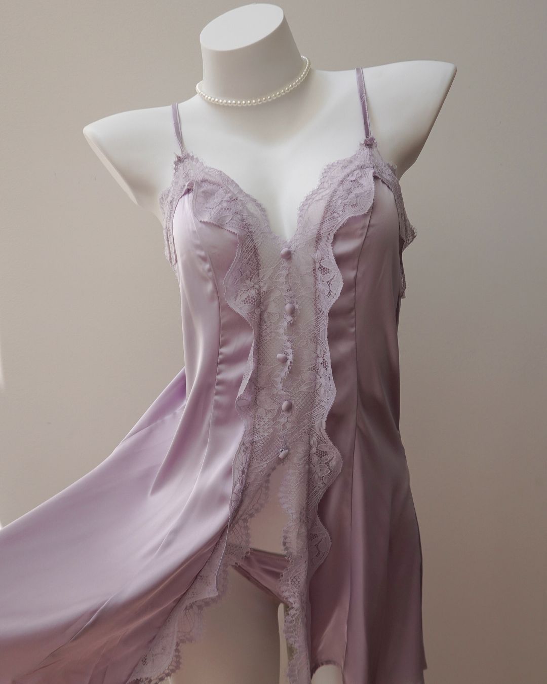 Lace-trimmed satin nightgown on a mannequin against a plain background
