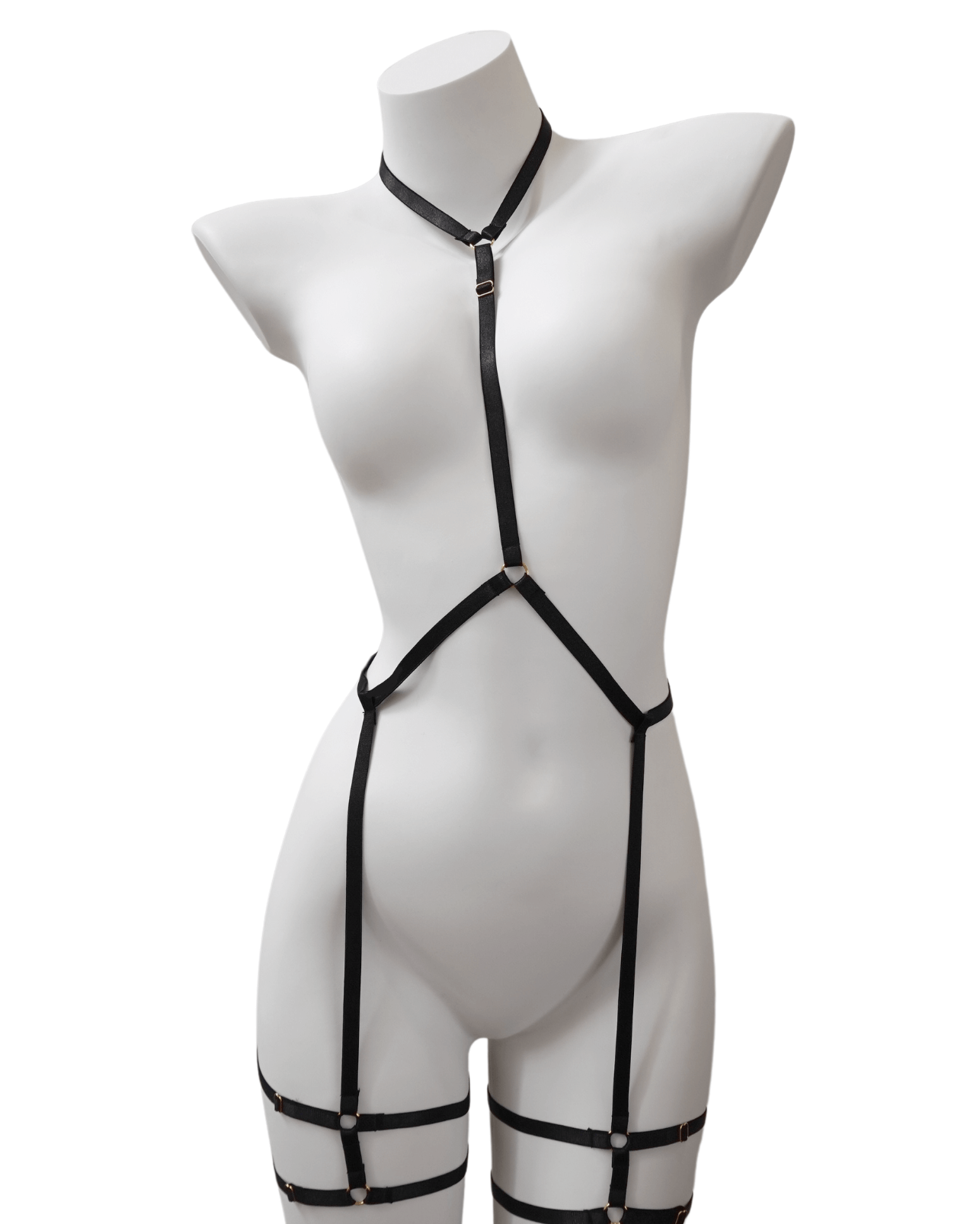 Minimalist black body harness with elastic neck, waist, and thigh straps – displayed on mannequin with silver ring accents