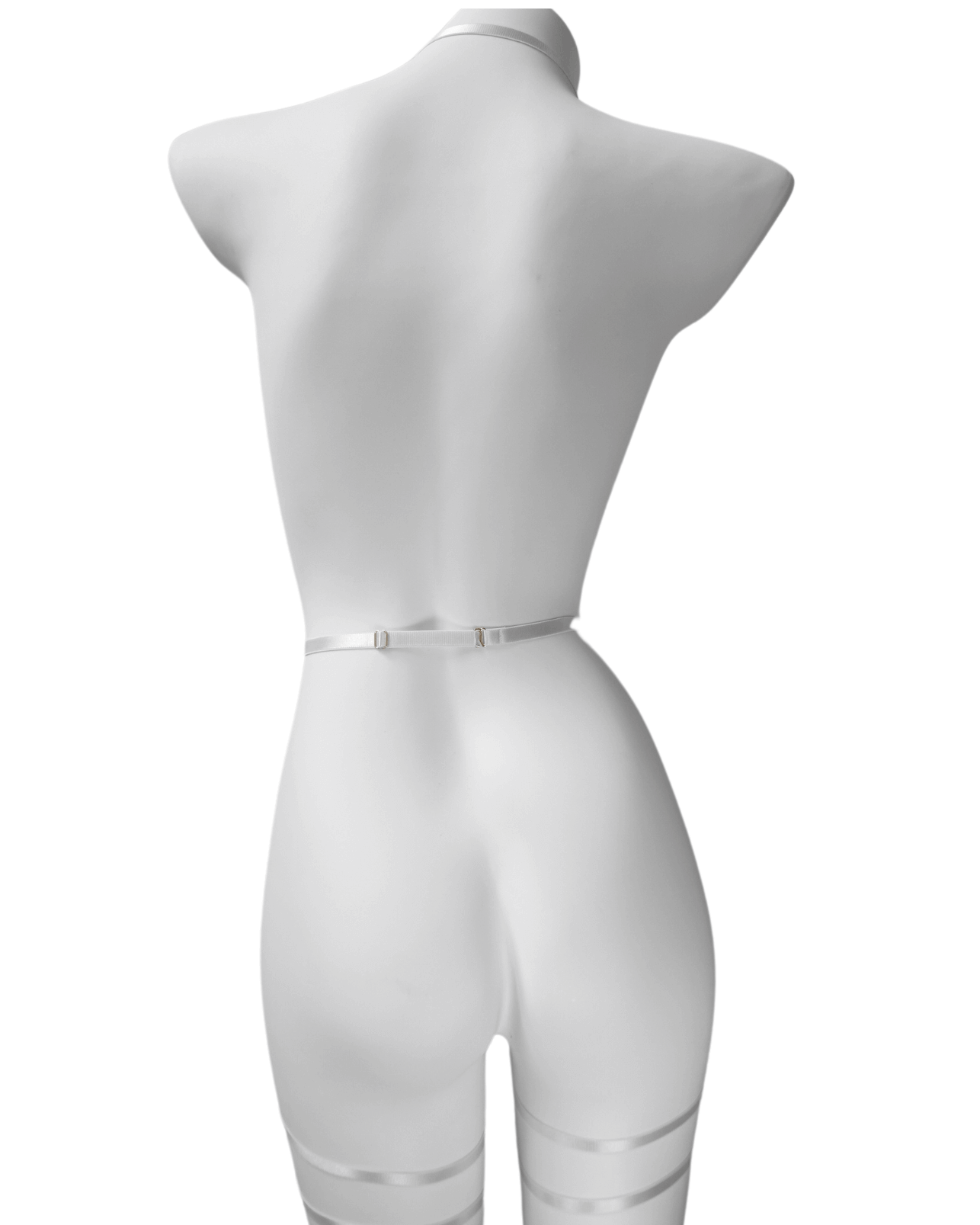 Back view of black strappy lingerie harness showing adjustable elastic fit and clean lines – soft bondage look