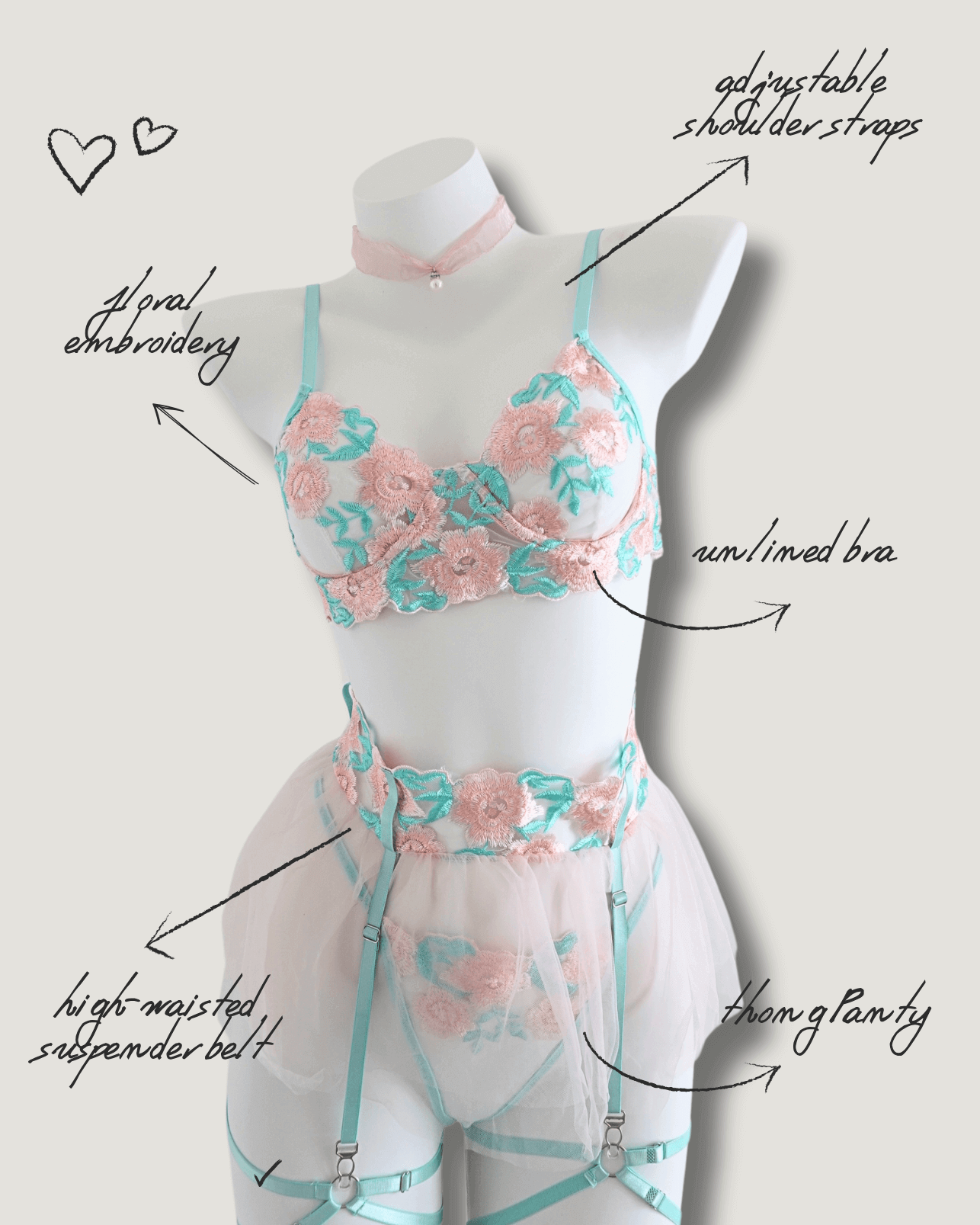Pastel pink and mint floral embroidered lingerie set displayed on mannequin – sheer mesh with unlined bra and high-waisted garter belt