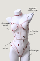 Pink mesh bodysuit with small rose embroidery – romantic and artistic design