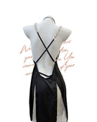 Black strappy dress on a mannequin with a white background