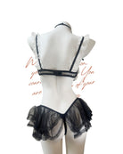 Black lace lingerie set on a mannequin against a white background
