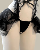 Black lace lingerie set on a mannequin against a neutral background