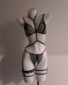 Black lace lingerie set on a mannequin against a neutral background