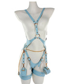 Pastel blue vegan-leather harness lingerie set with gold hardware and soft cuffs, adjustable straps, front view on white background.