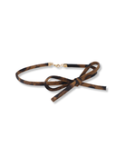 Brown leather belt with a bow on a white background
