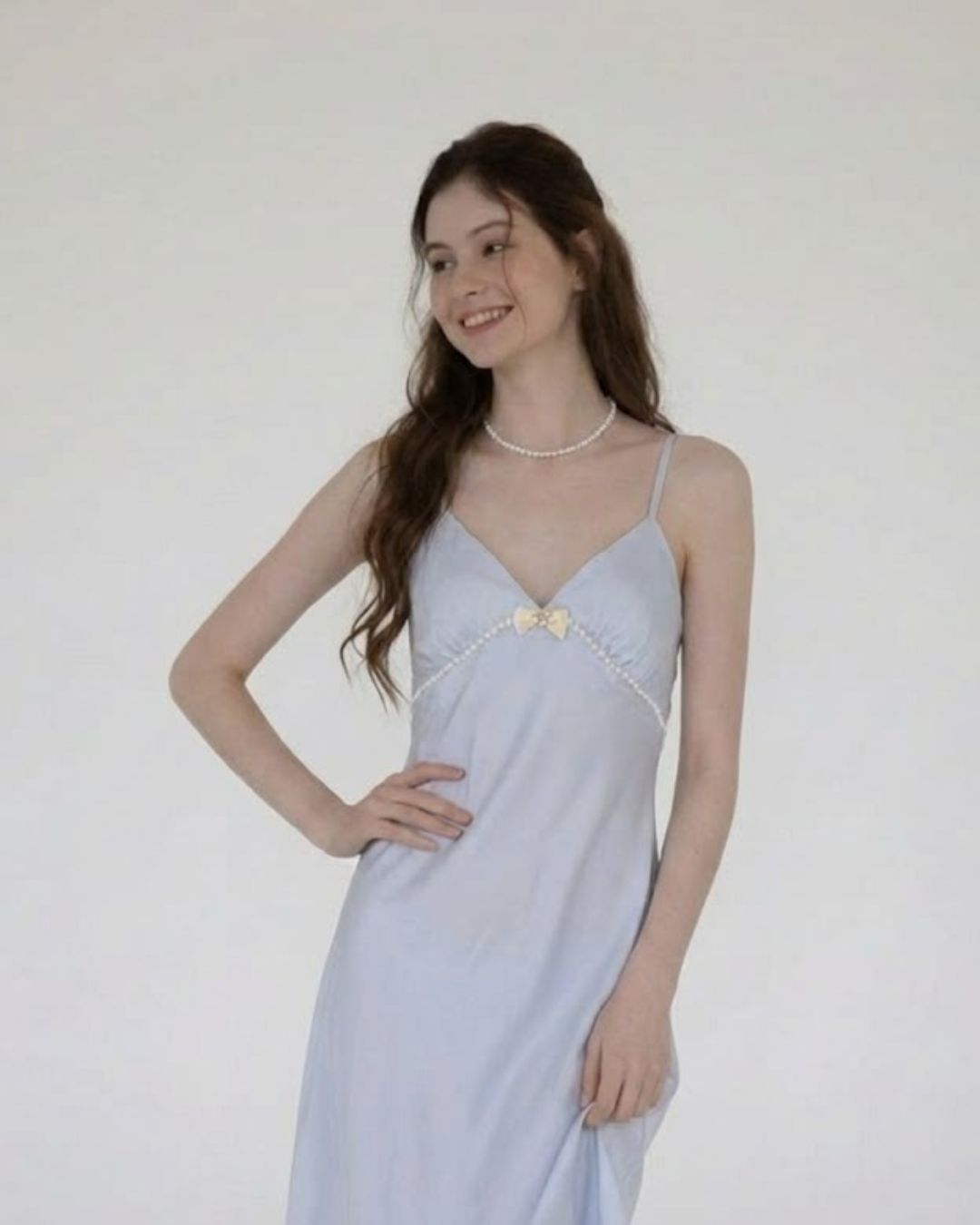 Woman wearing a FairyBerry light blue nightdress with a white background
