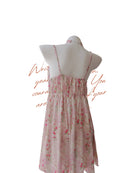 Floral dress on a mannequin with text overlay on a white background