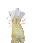 Yellow satin nightgown on a mannequin with a white background