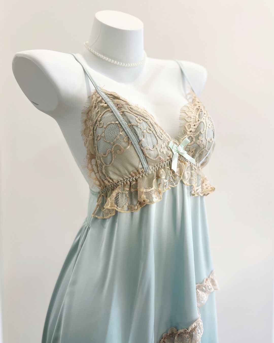 Mannequin wearing a fairyberry light blue nightdress with lace details on a plain background