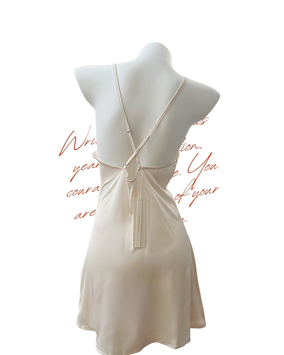 A back view of the Lilyveil Nightdress in ivory champagne, highlighting the flowing drape and diagonal lace detail. The fabric offers a silky feel with a soft shimmer, perfect for a romantic night in.