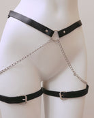 Black leather harness with chain details on a mannequin against a white background