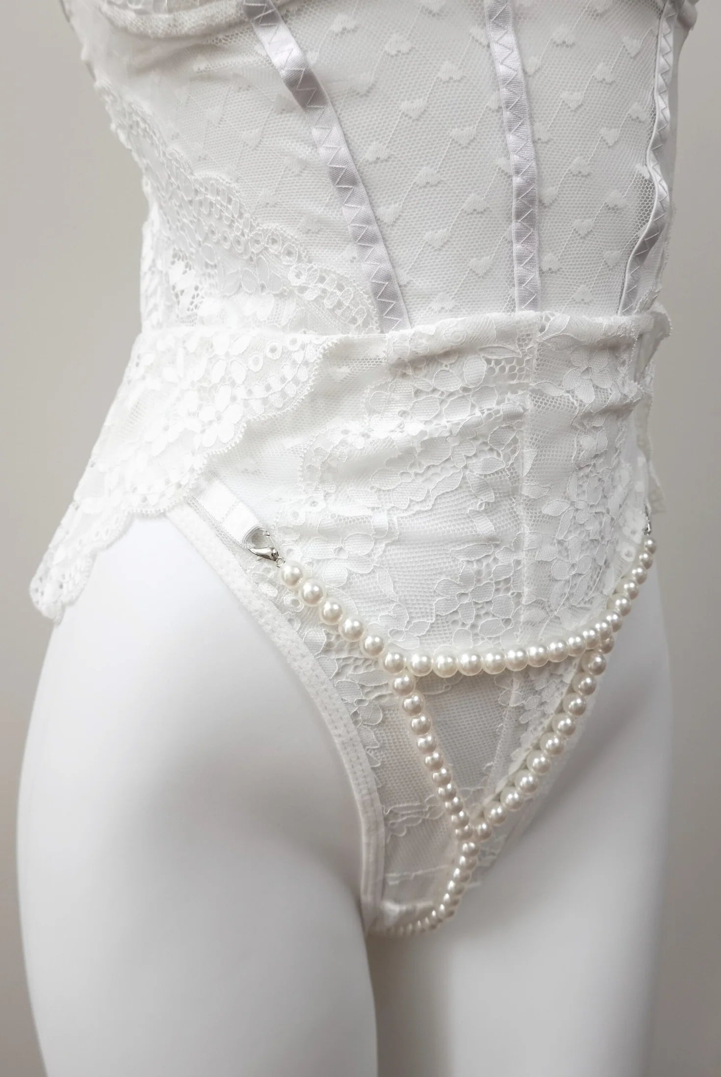 close-up view of Pearl Illusion Thong on white lace teddy lingerie