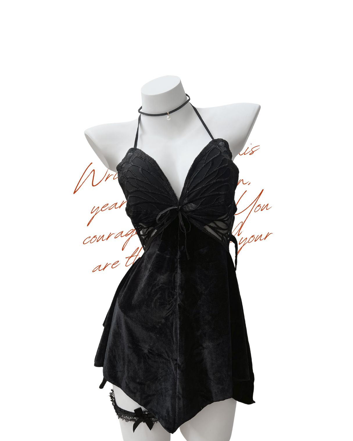 Black velvet  nightdress on a mannequin against a white background.