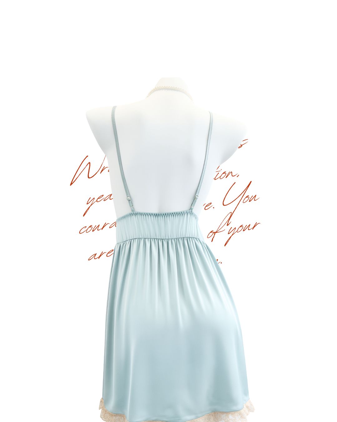 Light blue dress on a mannequin with cursive text on a white background