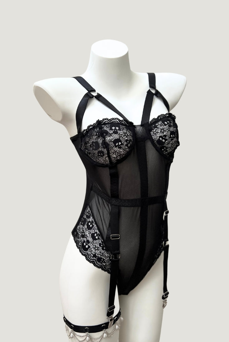 Mid-body view showing sheer black mesh panels, vertical shaping seams, and waist belt detail on the Ravenbite Bodysuit.