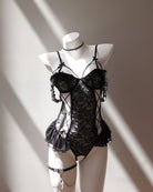Black lace lingerie set on a mannequin against a neutral background