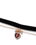 Black choker with a heart-shaped pendant featuring a cross on a white background