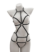 Black strappy garment on a mannequin against a white background