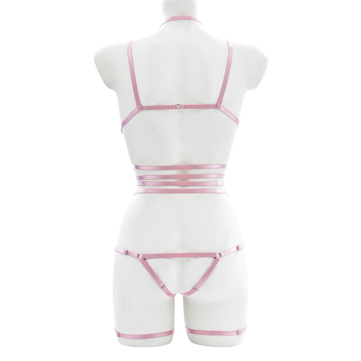 Back view of pink strappy lingerie harness showing elastic waist, thong cut, and adjustable shoulder and leg straps – soft bondage style