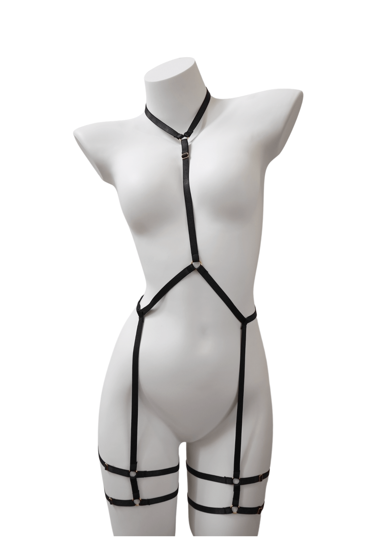 Minimalist black body harness with elastic neck, waist, and thigh straps – displayed on mannequin with silver ring accents