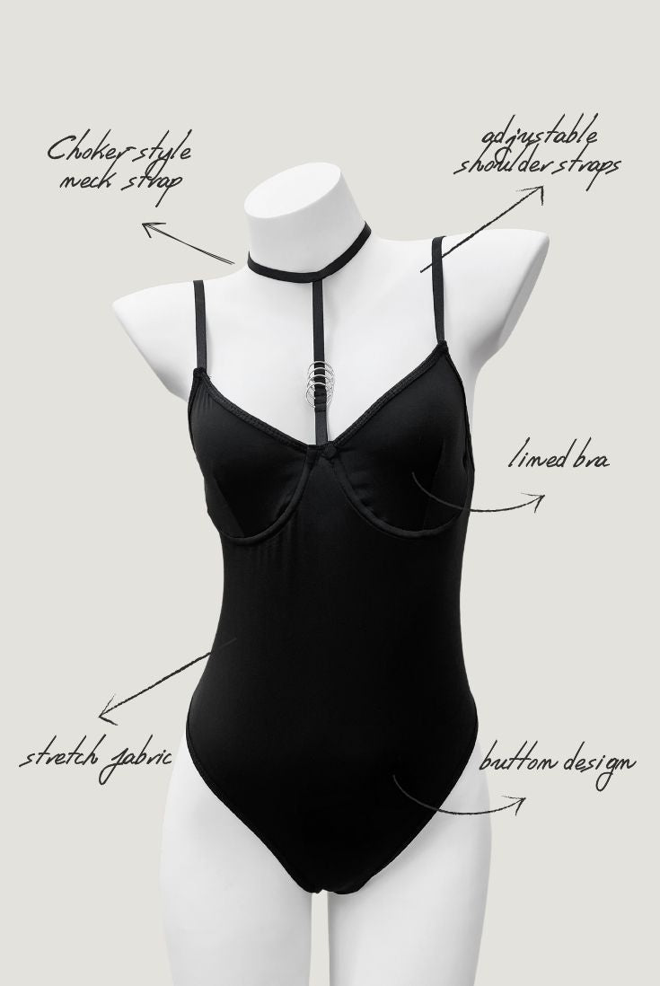 Black Moonlock Bodysuit featuring sleek matte fabric and silver ring detail on strappy neckline. Minimalist lingerie design.