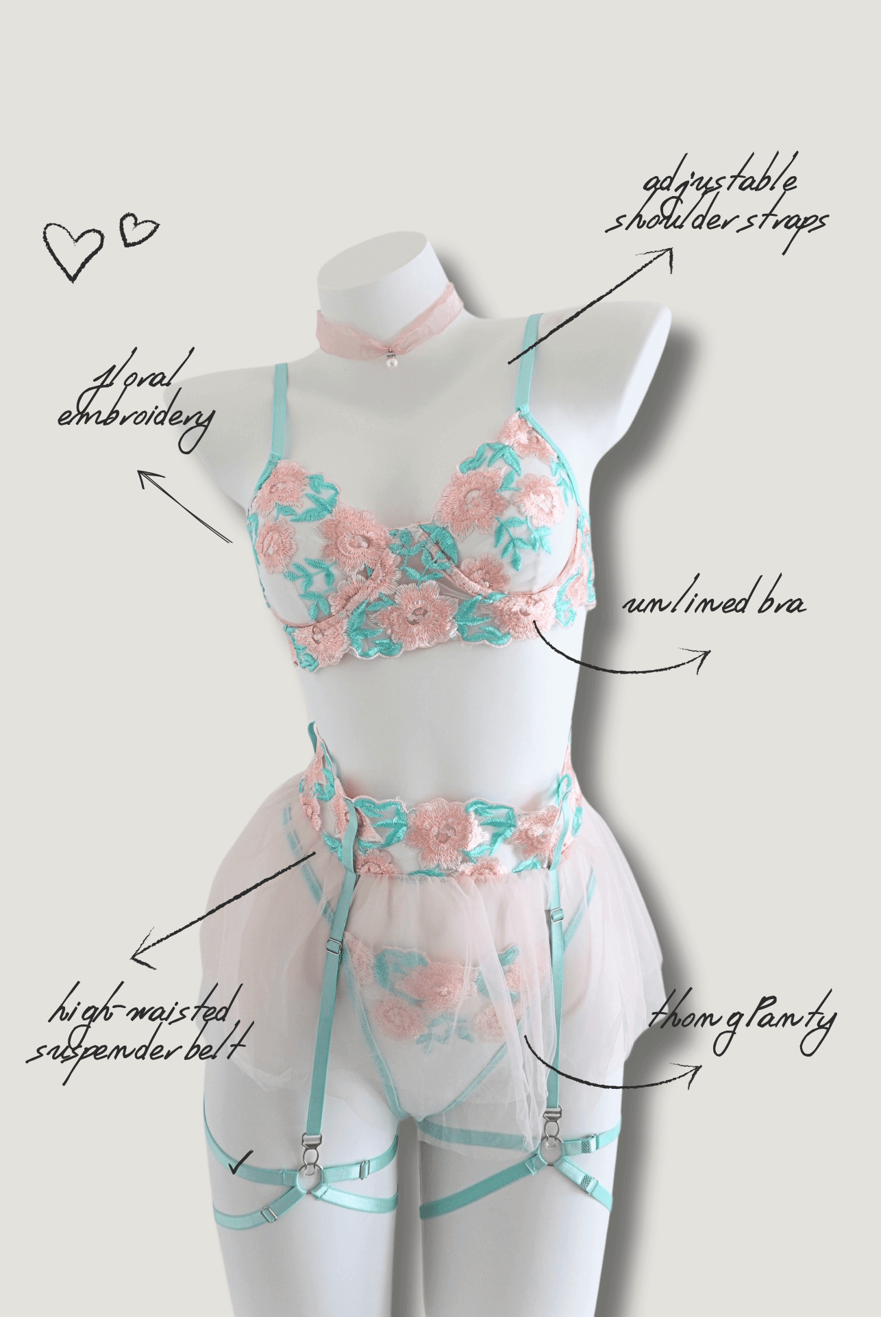 Pastel pink and mint floral embroidered lingerie set displayed on mannequin – sheer mesh with unlined bra and high-waisted garter belt
