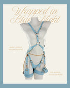 Soft sky-blue harness lingerie with gold accents and gentle cuffs, adjustable straps wrapping the body in a delicate front view. With sizing text.